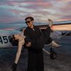 man and woman in black clothes and shades happy
